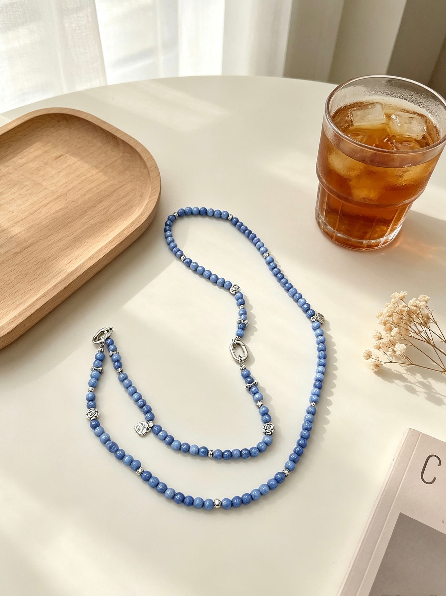 Blue beaded phone lanyard with silver charms