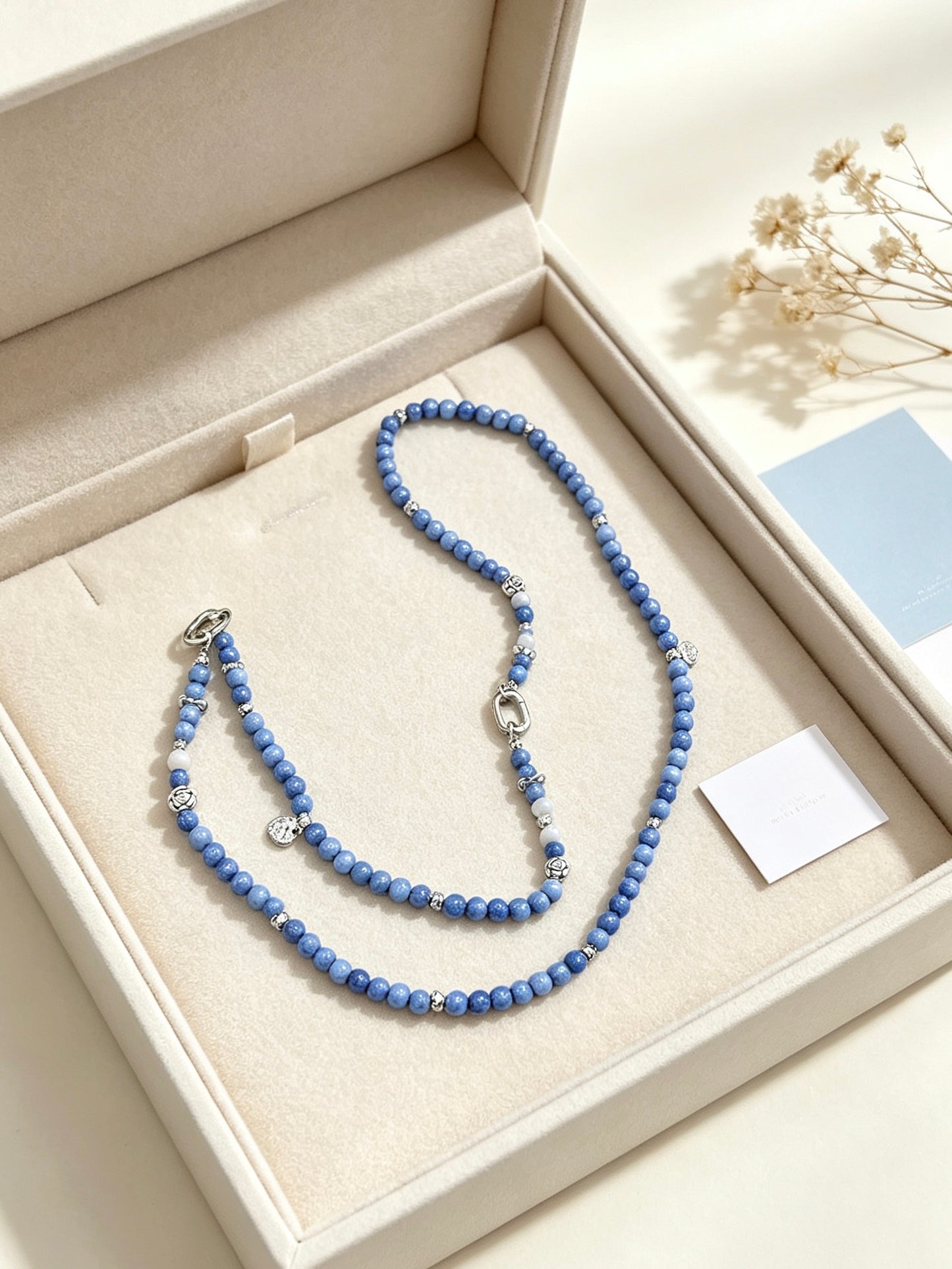 Blue beaded phone lanyard with silver charms